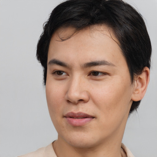 Joyful asian young-adult male with short  brown hair and brown eyes