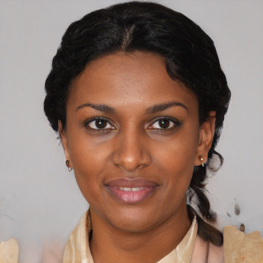 Joyful black young-adult female with short  brown hair and brown eyes