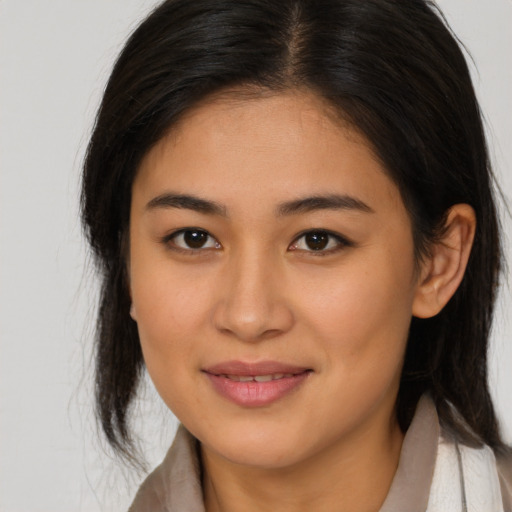Joyful asian young-adult female with medium  brown hair and brown eyes