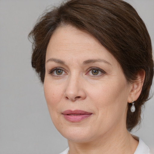 Joyful white adult female with medium  brown hair and brown eyes