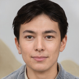 Joyful asian young-adult male with short  brown hair and brown eyes