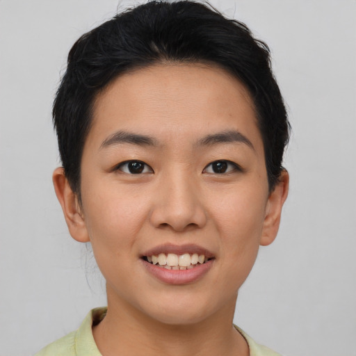 Joyful asian young-adult female with short  brown hair and brown eyes