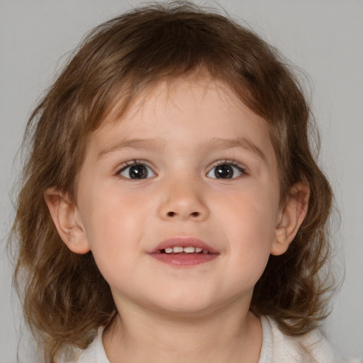 Joyful white child male with medium  brown hair and blue eyes