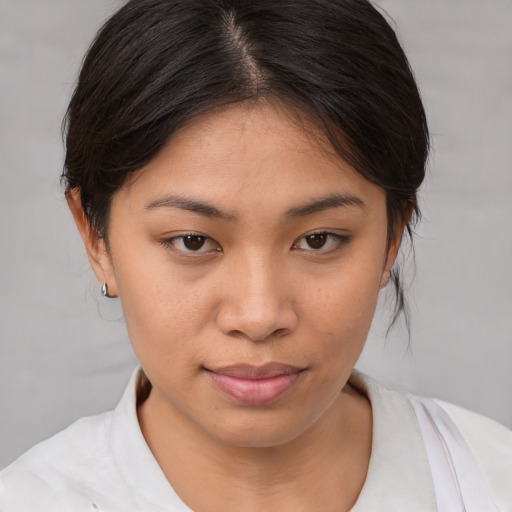 Joyful asian young-adult female with medium  brown hair and brown eyes