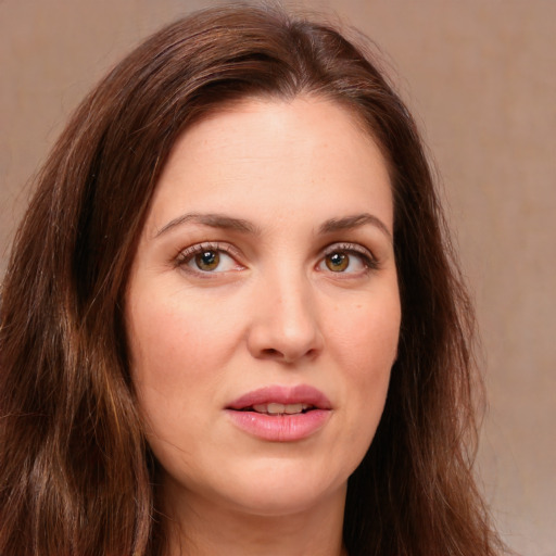 Joyful white young-adult female with long  brown hair and green eyes