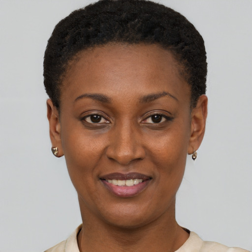 Joyful black young-adult female with short  black hair and brown eyes