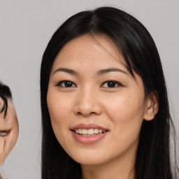 Joyful asian young-adult female with long  black hair and brown eyes