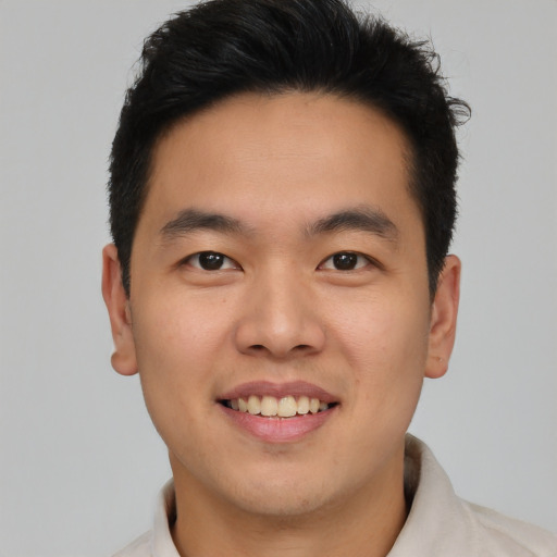 Joyful asian young-adult male with short  brown hair and brown eyes