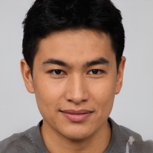 Joyful asian young-adult male with short  brown hair and brown eyes