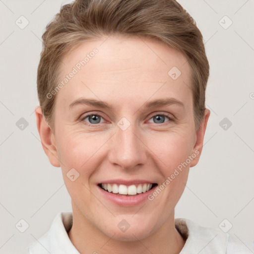 Joyful white young-adult female with short  brown hair and grey eyes