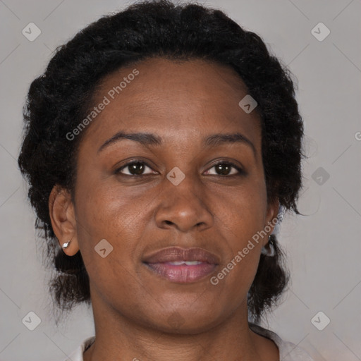 Joyful black adult female with short  brown hair and brown eyes