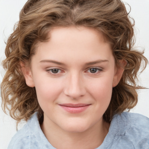 Joyful white child female with medium  brown hair and grey eyes