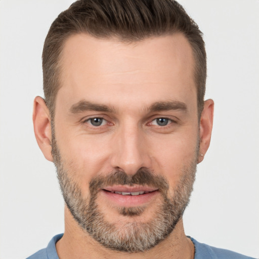 Joyful white adult male with short  brown hair and brown eyes