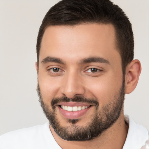 Joyful white young-adult male with short  brown hair and brown eyes