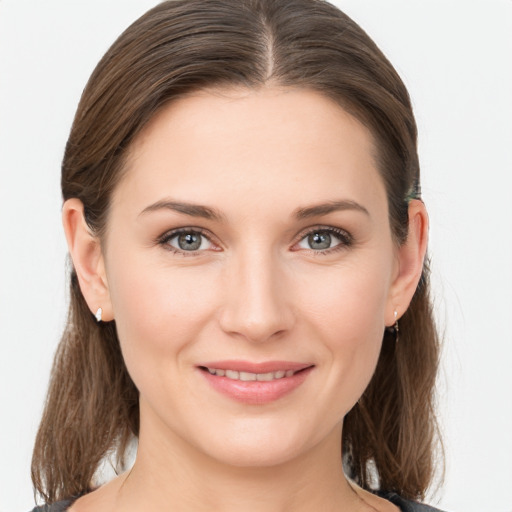 Joyful white young-adult female with medium  brown hair and grey eyes