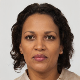 Joyful black adult female with medium  brown hair and brown eyes