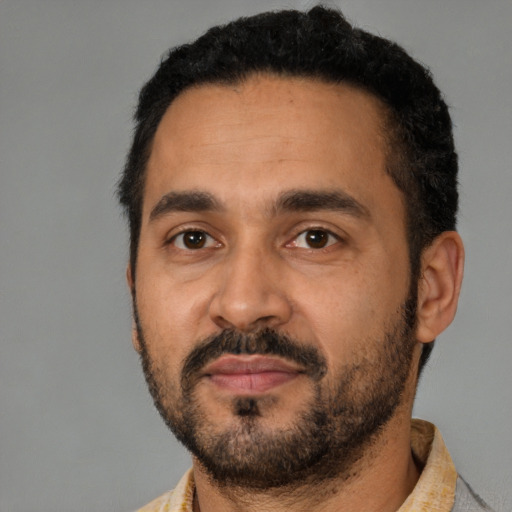 Neutral latino adult male with short  black hair and brown eyes