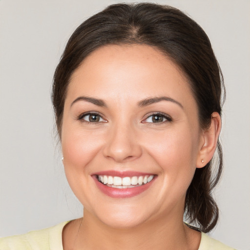 Joyful white young-adult female with medium  brown hair and brown eyes