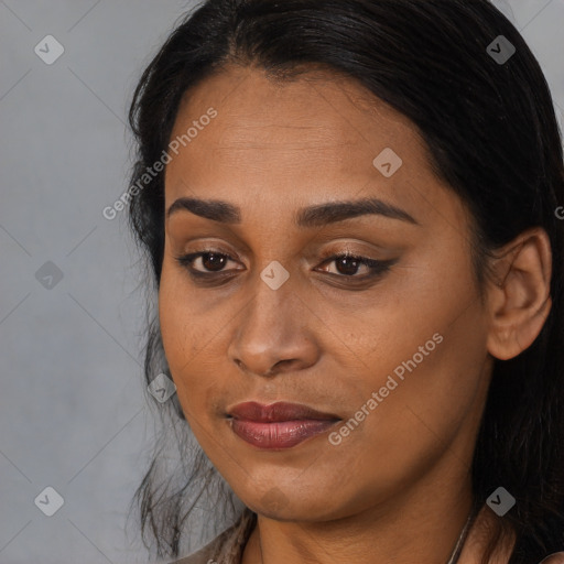 Joyful latino young-adult female with long  brown hair and brown eyes