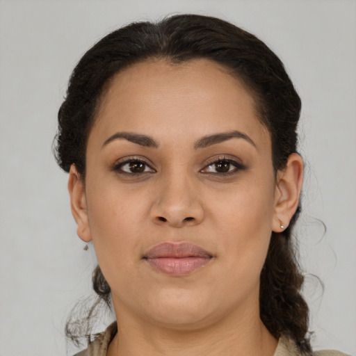 Joyful latino young-adult female with medium  brown hair and brown eyes