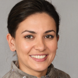 Joyful white young-adult female with medium  brown hair and brown eyes