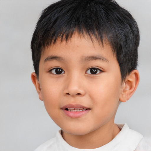 Joyful asian child male with short  brown hair and brown eyes