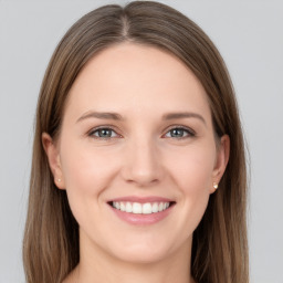 Joyful white young-adult female with long  brown hair and grey eyes