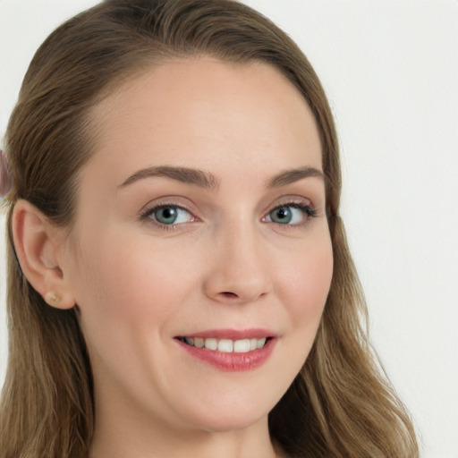 Joyful white young-adult female with long  brown hair and blue eyes