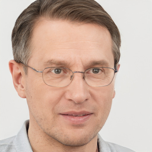 Joyful white adult male with short  brown hair and grey eyes