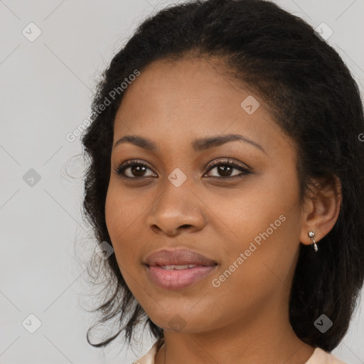 Joyful black young-adult female with long  black hair and brown eyes