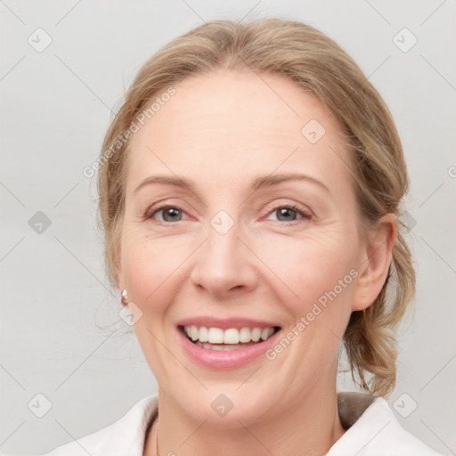 Joyful white adult female with medium  brown hair and blue eyes