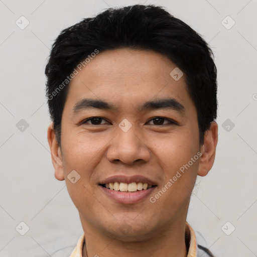 Joyful asian young-adult male with short  black hair and brown eyes