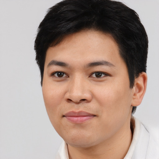 Joyful asian young-adult female with short  black hair and brown eyes