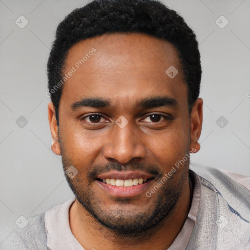 Joyful black young-adult male with short  black hair and brown eyes