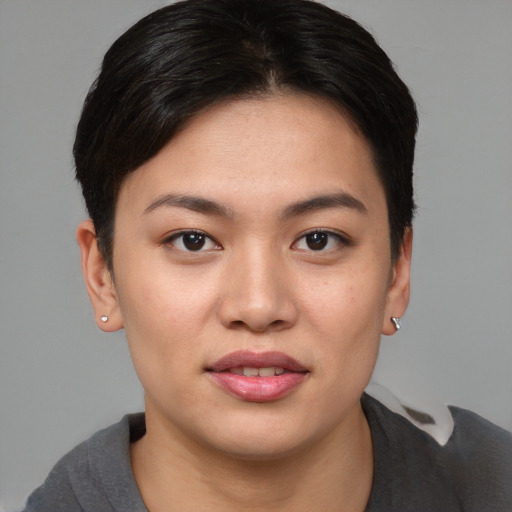 Joyful asian young-adult female with short  brown hair and brown eyes