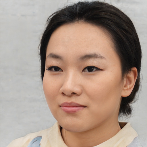 Joyful asian young-adult female with medium  brown hair and brown eyes