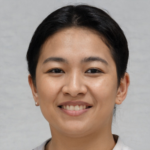 Joyful asian young-adult female with short  brown hair and brown eyes