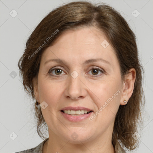 Joyful white adult female with medium  brown hair and grey eyes