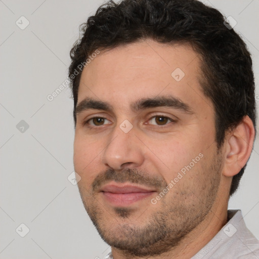 Joyful white young-adult male with short  black hair and brown eyes