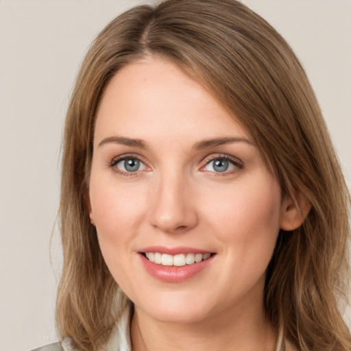 Joyful white young-adult female with medium  brown hair and grey eyes