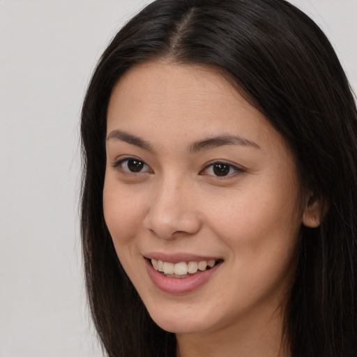 Joyful white young-adult female with long  brown hair and brown eyes