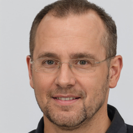 Joyful white adult male with short  brown hair and brown eyes