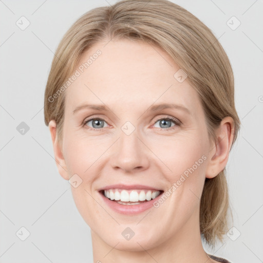 Joyful white young-adult female with medium  brown hair and blue eyes