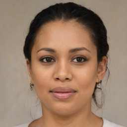 Joyful latino young-adult female with medium  brown hair and brown eyes