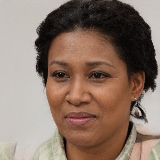 Joyful black adult female with short  brown hair and brown eyes