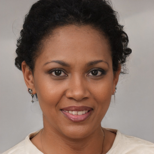 Joyful black young-adult female with short  brown hair and brown eyes