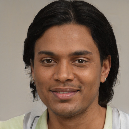 Joyful asian young-adult male with medium  black hair and brown eyes
