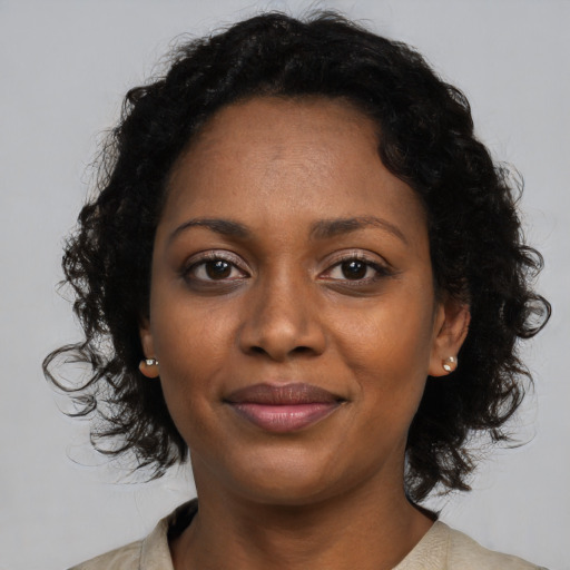 Joyful black young-adult female with medium  brown hair and brown eyes
