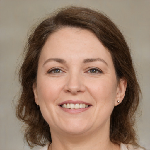 Joyful white adult female with medium  brown hair and brown eyes