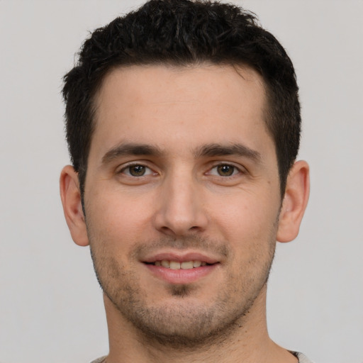 Joyful white young-adult male with short  brown hair and brown eyes